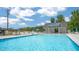 Community pool with clear blue water, comfortable lounge chairs, and a modern pool house for an enjoyable outdoor experience at 1100 Ursa Major Ct, Wendell, NC 27591