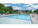 Community swimming pool featuring a clean, inviting design with ample seating and lounge chairs for relaxation and enjoyment at 1100 Ursa Major Ct, Wendell, NC 27591