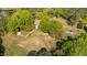 Panoramic aerial view of a white two-story home with a sprawling yard, gardens, and mature trees at 1188 Turner Rd, Creedmoor, NC 27522