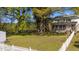 Expansive backyard featuring mature trees, a white picket fence, and a cozy picnic table under the shade at 1188 Turner Rd, Creedmoor, NC 27522