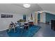 Spacious finished basement featuring a drum set, guitar, and blue carpeting perfect for music enthusiasts at 1188 Turner Rd, Creedmoor, NC 27522