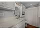 Well-lit bathroom with a white vanity, oval mirror, and convenient storage shelves near a curtained shower at 1188 Turner Rd, Creedmoor, NC 27522