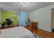 Bedroom with hardwood floors, painting easel, computer desk, and bed at 1188 Turner Rd, Creedmoor, NC 27522
