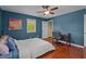 Bedroom with hardwood floors, two windows, desk, and ceiling fan at 1188 Turner Rd, Creedmoor, NC 27522