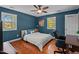 Bedroom with wood floors, many windows, desk, and ceiling fan at 1188 Turner Rd, Creedmoor, NC 27522