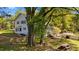 Charming two-story home with a screened porch, lush landscaping, and mature trees in a serene setting at 1188 Turner Rd, Creedmoor, NC 27522