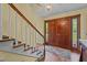 Elegant foyer with wooden staircase, classic chandelier, and views of the entry at 1188 Turner Rd, Creedmoor, NC 27522