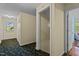Hallway with floral carpeting leads to rooms and stairs at 1188 Turner Rd, Creedmoor, NC 27522