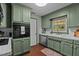 Updated kitchen featuring stainless steel appliances and beautiful sage green cabinets at 1188 Turner Rd, Creedmoor, NC 27522