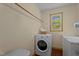 This laundry room features white front load washer and dryer and bright window at 1188 Turner Rd, Creedmoor, NC 27522