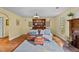Inviting living room features a leather sofa set, wooden floors, and a cozy fireplace at 1188 Turner Rd, Creedmoor, NC 27522