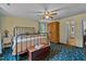The main bedroom has ceiling fan, vintage armoire, and view to the ensuite bath at 1188 Turner Rd, Creedmoor, NC 27522