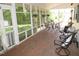 Relaxing screened porch with brick flooring, comfortable seating and views of the landscaped backyard at 1188 Turner Rd, Creedmoor, NC 27522