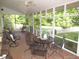 The screened porch is perfect for entertaining with brick flooring and views of the landscaped yard at 1188 Turner Rd, Creedmoor, NC 27522