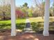 Lawn view from a column-lined front porch with a gravel path leading into the yard at 1188 Turner Rd, Creedmoor, NC 27522