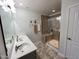 Bathroom with double vanity, stylish mirrors, and a large tiled shower with a built-in seat and glass door at 1208 Wind Rose Dr, Fuquay Varina, NC 27526