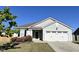 Charming single-story home featuring a well-manicured lawn, attached garage, and lovely rose bushes at 1208 Wind Rose Dr, Fuquay Varina, NC 27526