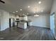 Open-concept kitchen with stainless steel appliances, granite counters, and a central island for modern living at 1208 Wind Rose Dr, Fuquay Varina, NC 27526