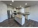 Bright kitchen featuring granite countertops, stainless steel appliances, and a functional center island at 1208 Wind Rose Dr, Fuquay Varina, NC 27526