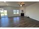 Living room with a fireplace, fan, and sliding door to the backyard, creating a comfortable, relaxing atmosphere at 1208 Wind Rose Dr, Fuquay Varina, NC 27526