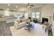 Open-concept living room with hardwood floors, vaulted ceilings, a fireplace, and seamless access to the kitchen at 1208 Wind Rose Dr, Fuquay Varina, NC 27526