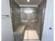 Close-up of walk-in shower with a glass enclosure, tiled walls, seating, and modern fixtures at 1208 Wind Rose Dr, Fuquay Varina, NC 27526