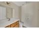 Comfortable bathroom with neutral walls, a well-lit mirror and vanity with wood cabinets at 1283 Schaub Dr # B, Raleigh, NC 27606