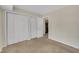 Bedroom featuring carpet, three closets, and access to another room at 1283 Schaub Dr # B, Raleigh, NC 27606