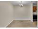 Open-concept dining area with carpet flooring, a modern chandelier, and easy access to the kitchen at 1283 Schaub Dr # B, Raleigh, NC 27606