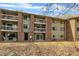 Apartment building with brick accents, multiple balconies, and a well-maintained yard with fallen leaves at 1283 Schaub Dr # B, Raleigh, NC 27606