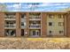Backside exterior view showing the multiple balconies on the three-story apartment building and green common area at 1283 Schaub Dr # B, Raleigh, NC 27606
