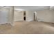 Bright living room with neutral walls, carpeted floors, and access to additional rooms at 1283 Schaub Dr # B, Raleigh, NC 27606