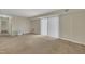 Spacious carpeted living room featuring sliding glass doors, neutral paint, and ample natural light at 1283 Schaub Dr # B, Raleigh, NC 27606