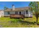 Backyard with a wooden deck and flourishing greenery at 133 Grassy Rio Ln, Garner, NC 27529