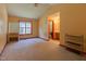 A large bedroom with carpet, and ample sunlight streaming through a big window at 133 Grassy Rio Ln, Garner, NC 27529