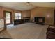 Spacious living room with fireplace, carpeted floor, and natural light from a window and glass door at 133 Grassy Rio Ln, Garner, NC 27529