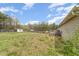 Expansive backyard featuring a wooden deck, storage shed, and full perimeter fencing at 141 Saige Ct, Burlington, NC 27217
