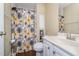 Bathroom featuring a single sink vanity and a shower with a floral curtain at 141 Saige Ct, Burlington, NC 27217