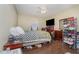 Bedroom with wood floors, a ceiling fan, a window, and coordinating furnishings at 141 Saige Ct, Burlington, NC 27217