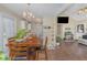 Inviting dining area with hardwood floors, a chandelier, and a view into the adjacent living room at 141 Saige Ct, Burlington, NC 27217