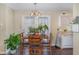 Cozy dining area with hardwood floors, a wood table, and a view of the kitchen at 141 Saige Ct, Burlington, NC 27217