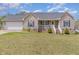 Charming single-Gathering home with light beige siding, complemented by a well-maintained green lawn at 141 Saige Ct, Burlington, NC 27217