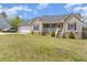 Charming single-Gathering home with light beige siding, complemented by a well-maintained green lawn at 141 Saige Ct, Burlington, NC 27217
