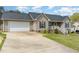 Charming single-Gathering home with light beige siding, complemented by a well-maintained green lawn at 141 Saige Ct, Burlington, NC 27217