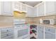 Traditional kitchen featuring white cabinets, an electric range, and corner storage solution at 141 Saige Ct, Burlington, NC 27217
