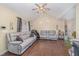 Open-concept living room boasts hardwood floors, comfortable gray couches, and abundant natural light at 141 Saige Ct, Burlington, NC 27217