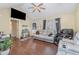Comfortable living room features hardwood floors, a mounted TV, a ceiling fan, and gray couches at 141 Saige Ct, Burlington, NC 27217