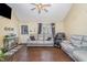 Spacious living room featuring hardwood floors, a ceiling fan, and comfortable gray leather furniture at 141 Saige Ct, Burlington, NC 27217
