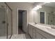 Bathroom featuring dual sinks, large mirror, and walk in shower at 144 E Victory View Ter # 66, Smithfield, NC 27577