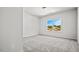 Bright bedroom with plush carpet and a large window overlooking a scenic view at 144 E Victory View Ter # 66, Smithfield, NC 27577
